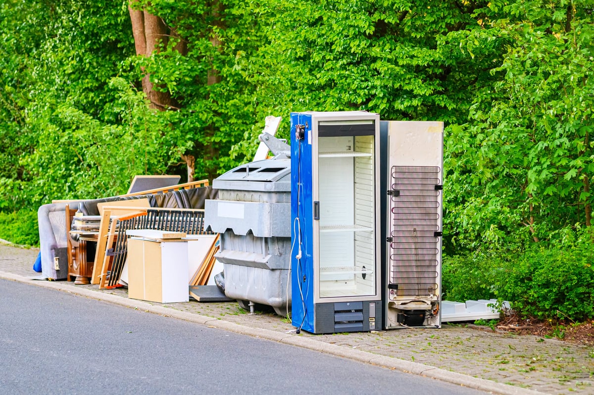 Discarded household appliances piled at the roadside for collection